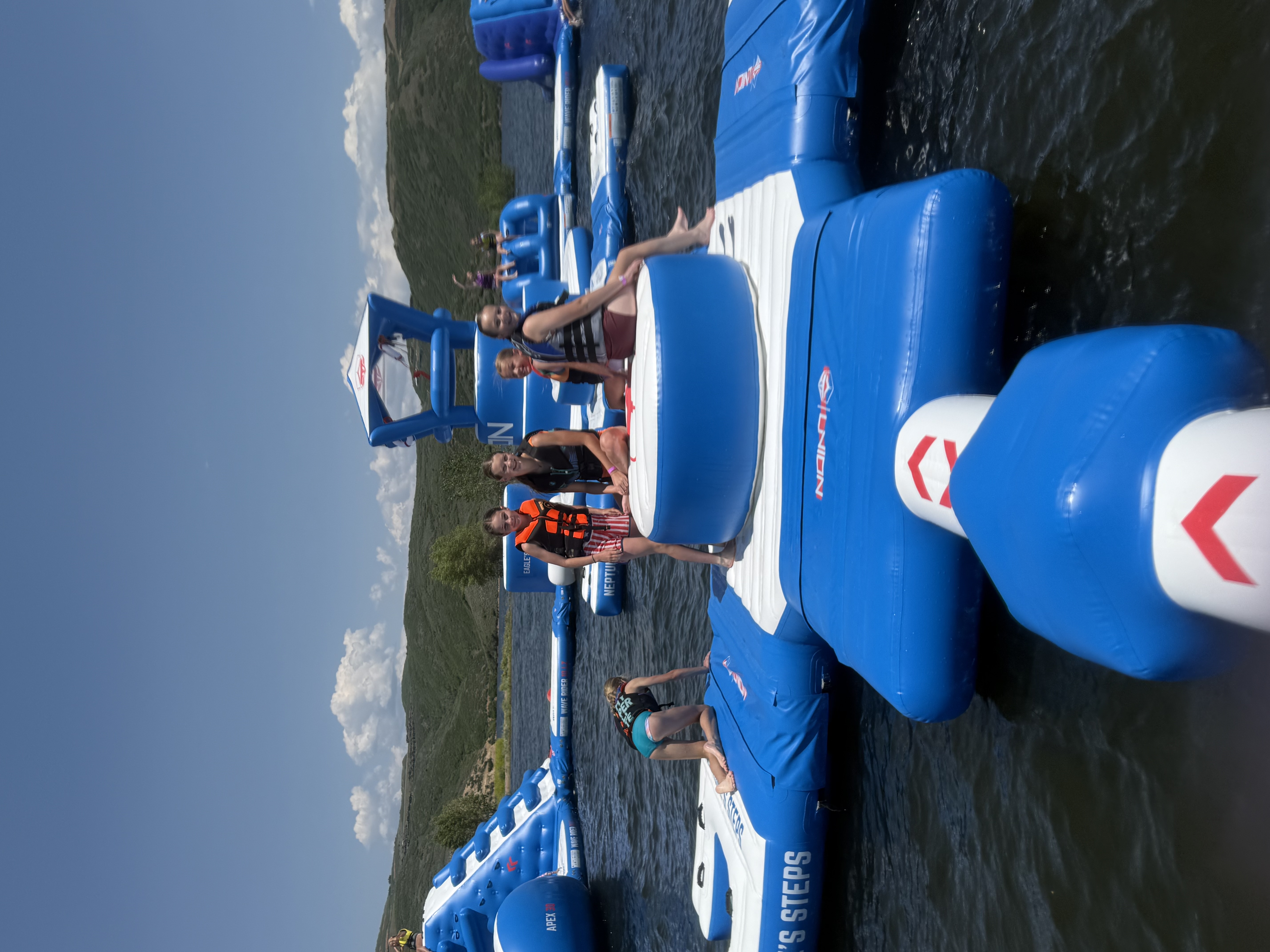 Kids playing on the Jordanelle Aqua Park floating obstacle course
